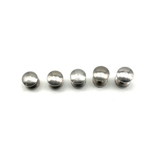 May include: Five silver metal round-headed push buttons.