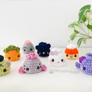 May include: A collection of small, handmade crochet plushies in various shapes and colors, including a green monster, orange pumpkin, grey creature, black blob, white ghost, candy corn, and purple monster, with the text Easy Crochet Plushies.