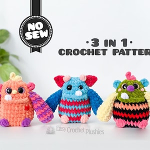 May include: Three colourful crochet monster plushies. The monsters are orange, blue, and green with various coloured arms, bodies, and accents. The image includes the text "NO SEW" and "3 IN 1 CROCHET PATTERN".