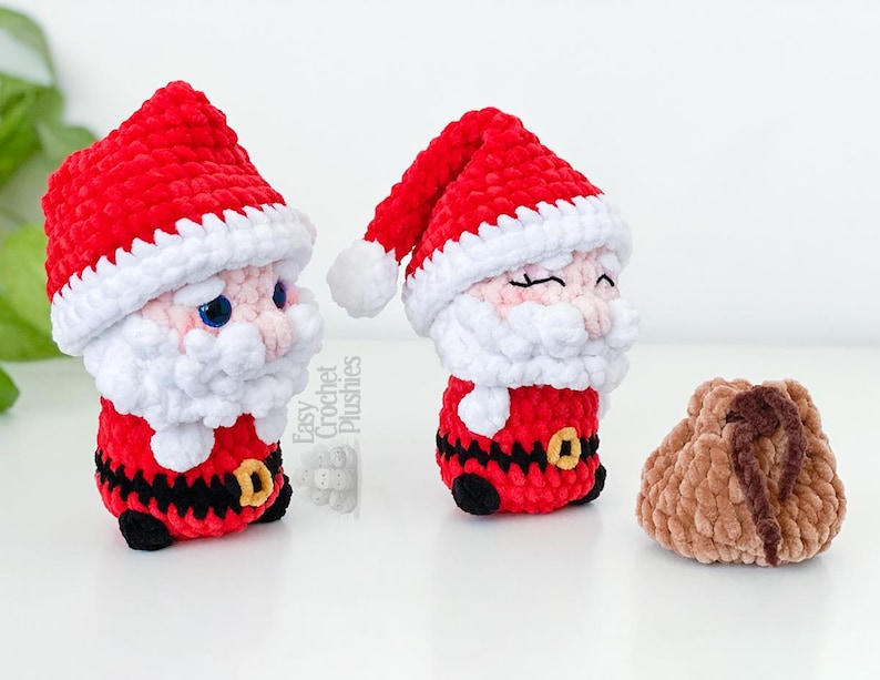 May include: Two handmade crochet Santa Claus figures with red hats and white beards, and a small brown pouch. The Santa figures have black belts with gold buckles. The text "Easy Crochet Plushies" is visible.