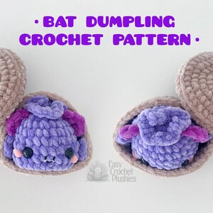 May include: A crochet pattern titled BAT DUMPLING CROCHET PATTERN with a NO SEW badge. The image displays two plush bats, each nestled inside a light brown crocheted shell. The bats are purple with dark purple ears, black eyes, and pink cheeks.