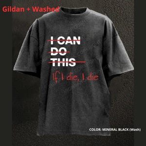 May include: A mineral black, washed t-shirt with the text "I CAN DO THIS" crossed out in red, and the phrase "If I die, I die" in red. The shirt is a dark gray color.