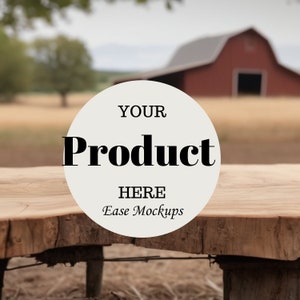 May include: A rustic wooden table top with a white circle overlay that says "YOUR Product HERE Ease Mockups". The table is in front of a blurred background of a red barn and a field.