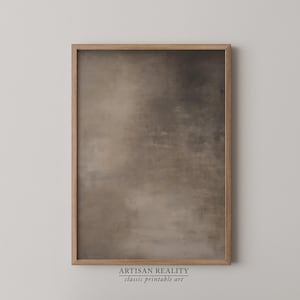 May include: A framed print with a neutral color palette. The artwork features a blend of brown and gray tones, creating a textured, abstract design. The frame is made of light-colored wood. The text at the bottom reads "ARTISAN REALITY classic printable art."