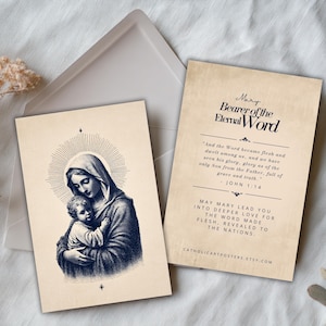 May include: Two religious art prints featuring a vintage-style illustration of Mary and baby Jesus, with a radiant halo. The second print has text that reads "Mary Bearer of the Eternal Word" and a Bible verse. The prints are on a cream-colored background.