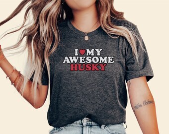 May include: A dark grey t-shirt with the text "I love my awesome husky" in white and red letters. The heart in the text is red.
