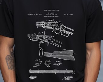 May include: A black t-shirt featuring a white graphic print of the 1860 United States patent for the B.T. Henry magazine fire arm. The design includes technical diagrams labelled Fig. 1 through Fig. 9, showing the rifle mechanism and parts.