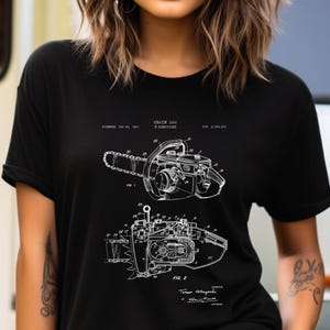 a woman wearing a black shirt with a drawing of a camera