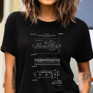 May include: A black short-sleeved t-shirt featuring a white technical patent illustration titled Semiconductor Device-and-Lead Structure. The graphic includes detailed schematics labeled Fig-3, Fig-4, and Fig-5, along with patent text and dates.