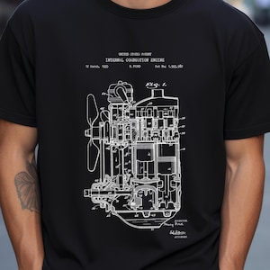 May include: A black short-sleeved t-shirt featuring a white graphic print of a United States Patent for an internal combustion engine. The design includes technical diagrams, the text "Internal Combustion Engine," "12 March, 1935," and "Pat No: 1,993,982."