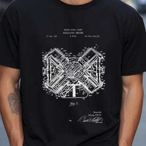 May include: A black t-shirt featuring a white graphic print of a United States Patent for an Explosive Engine by H. Ford, dated 16 Aug, 1927, Pat No: 1,639,355. The design includes a technical engine diagram labeled Fig. 1 and a signature.