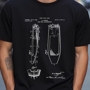 May include: Black t-shirt featuring a white boat hull construction patent diagram. The diagram includes detailed technical drawings, patent information, and the inventor's signature. The patent date is January 17, 1939.