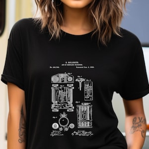 May include: A black short-sleeved t-shirt featuring a white graphic print of the H. Hollerith patent for the art of compiling statistics, dated January 8, 1889, including technical diagrams labeled Fig 1 through Fig 6 and patent text.