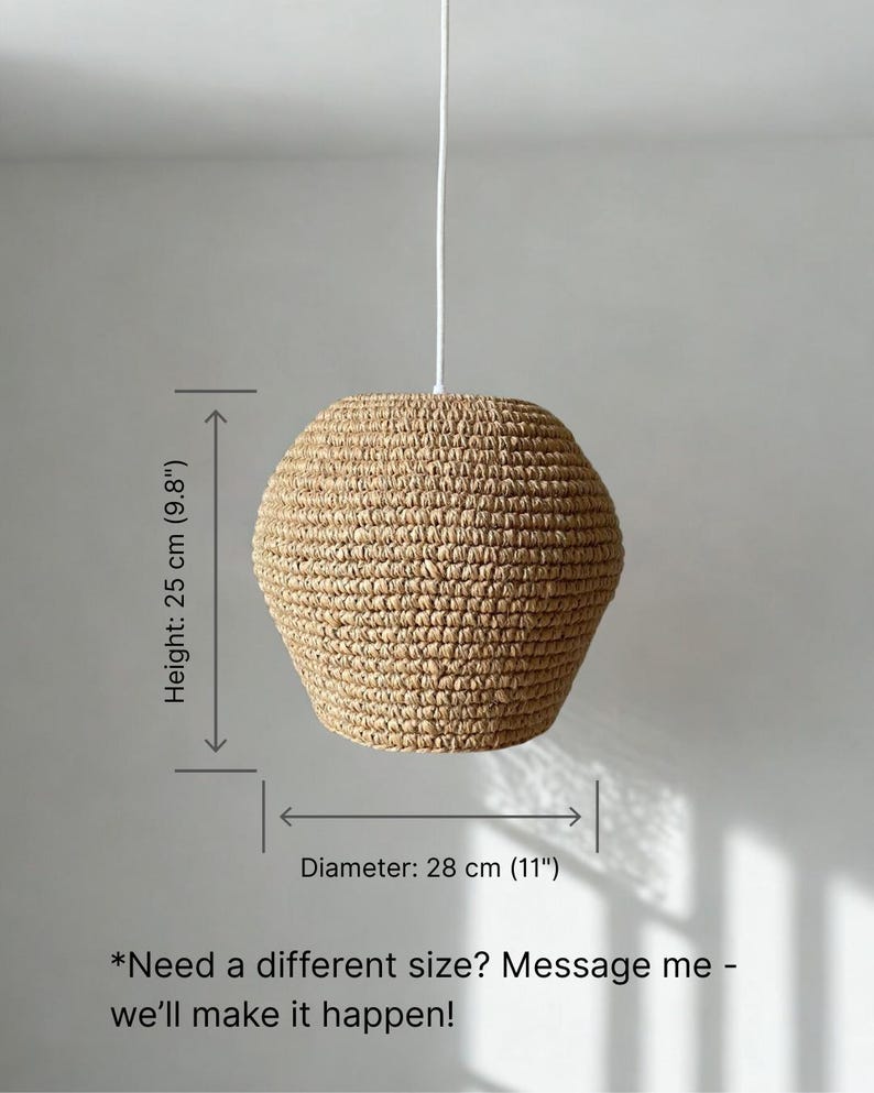 May include: A woven pendant light fixture with a natural, beige color. The lamp has a diameter of 11 inches and a height of 9.8 inches. It hangs from a white cord. The lamp's textured surface is visible.
