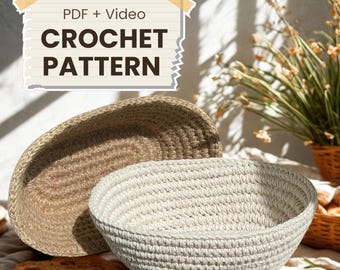 May include: Two handmade crochet baskets, one beige and one light gray, are displayed. The baskets are oval-shaped and have a textured appearance. The image includes the text "PDF + Video CROCHET PATTERN" in a decorative banner.