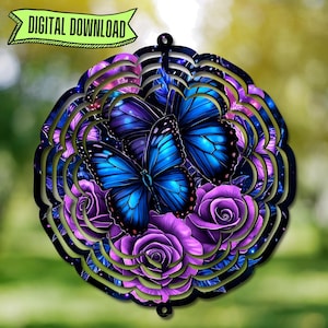 May include: A metal wind spinner with a circular design featuring two blue butterflies and purple roses. The butterflies have intricate details and are set against a dark blue background with a galaxy-like pattern.