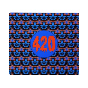 May include: A rectangular mat featuring a repeating pattern of blue and orange leaf-like shapes on a black background. In the center, a blue circle contains the number 420 written in a bold, orange, dripping-style font across the surface.