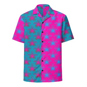 May include: A short-sleeve button-down shirt featuring a split-panel design with a teal left side and a bright pink right side. The entire garment is covered in a repeating floral pattern in contrasting pink and blue hues, with a classic collar.