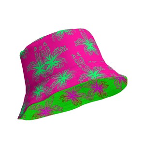 May include: A reversible bucket hat featuring a vibrant hot pink base with a repeating bright green palm tree pattern on one side, and a bright green base with a repeating hot pink palm tree pattern on the underside of the brim.
