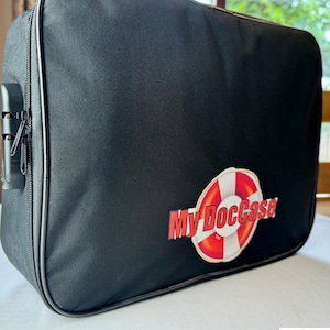 May include: Black zippered travel bag with a red and white life preserver logo that says "My DocCase".