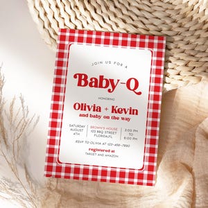May include: Red and white checkered baby shower invitation with the text "Join us for a Baby-Q honoring Olivia + Kevin and baby on the way". The invitation includes the date, time, location, and RSVP information. It also states that the couple is registered at Target and Amazon.