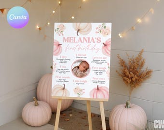 May include: A first birthday sign on an easel, featuring the name "Melania" and details about the baby. The sign includes a photo, pumpkin illustrations, and text in pink. The baby is 29 inches tall and weighs 20 pounds.