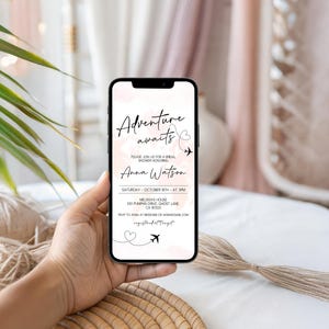 May include: A smartphone displays a bridal shower invitation with the text "Adventure awaits." The invitation includes the name "Anna Watson," date, time, and location. The background features a soft pink watercolor design with airplane and heart graphics.