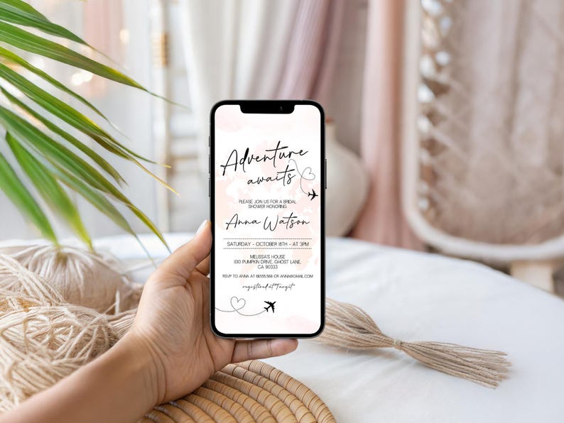 May include: A smartphone displays a bridal shower invitation with the text "Adventure awaits." The invitation includes the name "Anna Watson," date, time, and location. The background features a soft pink watercolor design with airplane and heart graphics.