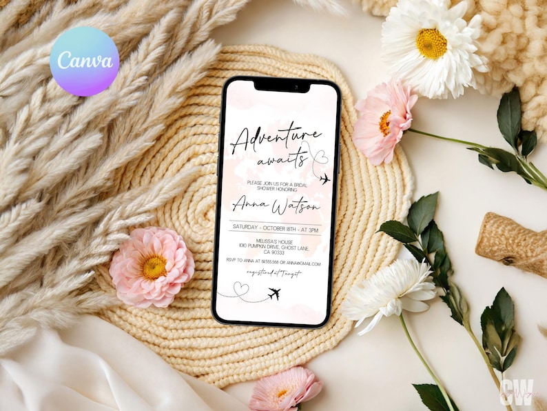 May include: A smartphone displays a bridal shower invitation with the text "Adventure awaits" and details for Anna Watson's shower. The phone rests on a woven mat, surrounded by flowers and decorative elements.