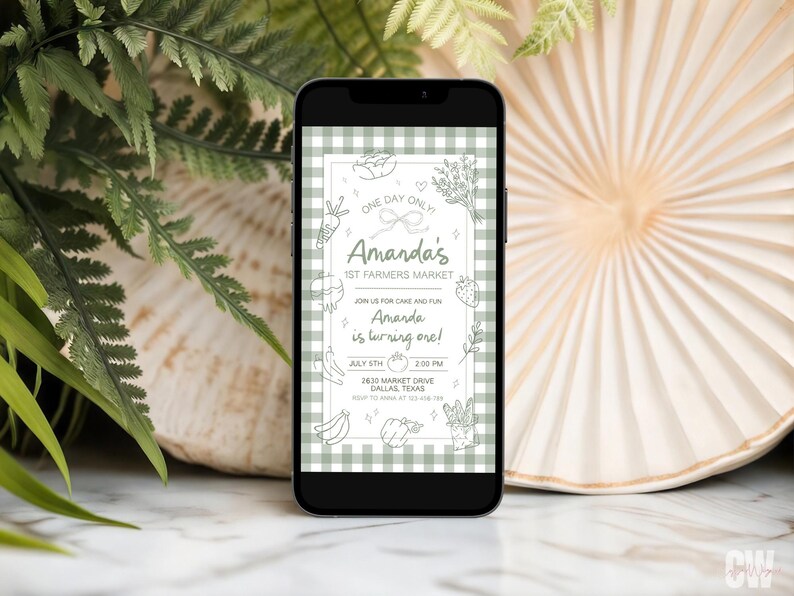 May include: A smartphone displays a digital invitation for Amanda's 1st Farmers Market, with a green gingham background. The invitation features hand-drawn illustrations of produce and the text "Amanda is turning one!" The date is July 5th.