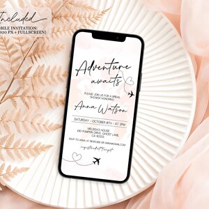 May include: A mobile invitation on a smartphone, featuring the text "Adventure awaits" with a heart and airplane graphic. The invitation is for a bridal shower honoring Anna Watson, with date, time, and location details. The phone rests on a white plate with a soft pink background.