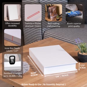 May include: A white rectangular box with a lid, measuring 10.82 inches by 7.16 inches and 1.73 inches high. The box is on a wooden table. The box is resistant to weight up to 26.46 pounds. The box has a thicker structure and offers increased durability.
