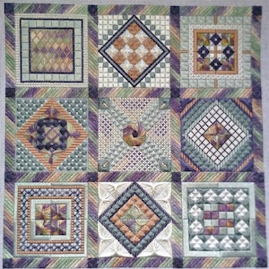 May include: A sampler with nine different cross-stitch patterns. The patterns are in shades of green, purple, brown, and white. The patterns are arranged in a grid.
