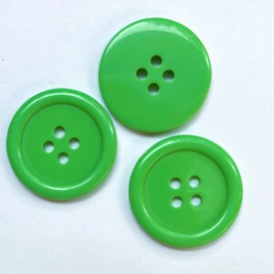 May include: Three green plastic buttons with four holes each.