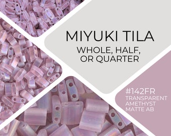 May include: A close-up of a pile of small, light purple, rectangular beads. The beads are Miyuki Tila beads, available in whole, half, or quarter sizes. The beads are labeled #142FR Transparent Amethyst Matte AB.