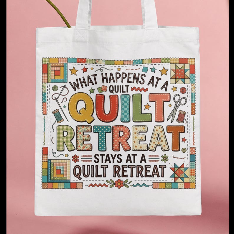 May include: White tote bag with the text "WHAT HAPPENS AT A QUILT RETREAT STAYS AT A QUILT RETREAT" in colorful letters. The design includes images of sewing tools and quilt block patterns.