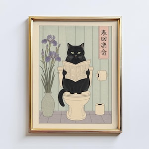 May include: A framed print featuring a black cat sitting on a toilet and reading a newspaper. The cat is in a bathroom setting with a vase of purple flowers and a roll of toilet paper. The print has a gold frame and a Japanese aesthetic.