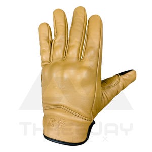 Peut inclure: Gant en cuir beige avec bordure noire. Le gant pr&eacute;sente un rembourrage renforc&eacute; sur les jointures et la paume. Le logo de la marque est visible sur le poignet. Con&ccedil;u pour la protection et la durabilit&eacute;.