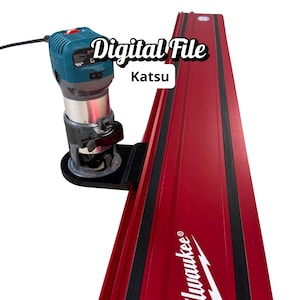 May include: A red and black guide rail system with a blue and silver router attached. The text "Digital File" and "Katsu" are visible. The Milwaukee logo is printed on the rail.