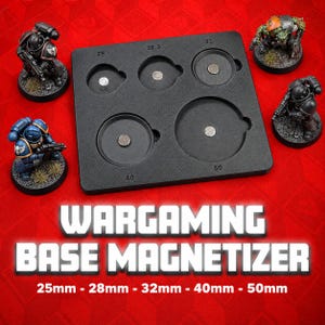 May include: A black plastic wargaming base magnetizer tool featuring five circular recessed slots labeled 25, 28.3, 32, 40, and 50, each containing a small circular magnet. The text WARGAMING BASE MAGNETIZER 25mm - 28mm - 32mm - 40mm - 50mm is visible.