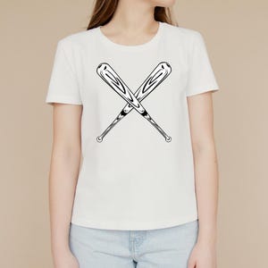 May include: White t-shirt with a black graphic of two crossed baseball bats.