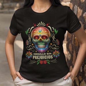 May include: A black t-shirt with a colorful sugar skull design and the text "Orgullo Sin Prejuicios".
