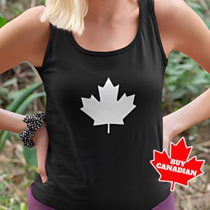 May include: Black tank top with a white maple leaf design. The text "BUY CANADIAN" is on a red maple leaf.