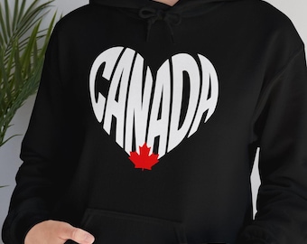 May include: Black hoodie with a white heart-shaped design that says "CANADA" with a red maple leaf inside the heart.