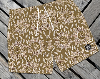 May include: Brown swim trunks with a white floral pattern. The trunks have a drawstring waistband and a small logo patch on the side.
