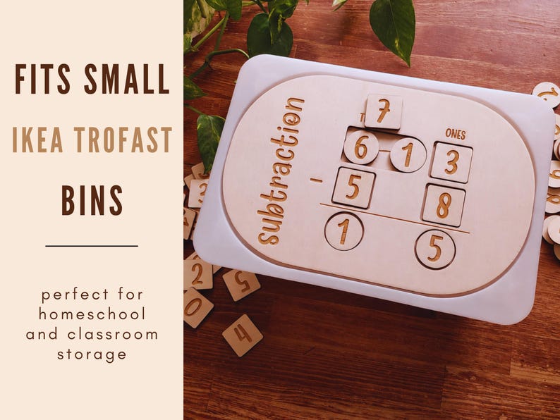 May include: A wooden subtraction learning toy with a white border. The toy has cutouts for number tiles and the word "subtraction" is printed on the side. The image also shows loose number tiles and the text "FITS SMALL IKEA TROFAST BINS".