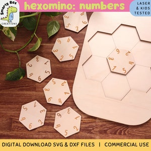 May include: A wooden hexomino puzzle with a light brown background. The puzzle is made up of six hexagonal pieces, each with a different number from 1 to 6. The pieces are arranged in a circle, with the numbers facing outwards. The puzzle is labeled "hexomino: numbers" and "laser & kids tested".