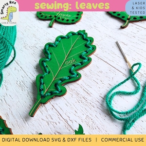 May include: Green wooden leaf cutouts for sewing projects. The image shows an oak leaf with the word "oak" and a poplar leaf. The leaves are decorated with green thread. A needle and thread are also visible. The text "sewing: leaves" is at the top.