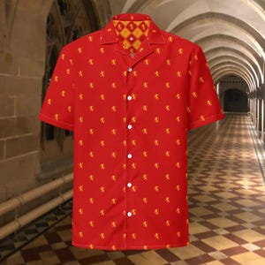 May include: Red short-sleeved shirt with a repeating gold lion motif. The collar has a yellow and red diamond pattern. The shirt fastens with white buttons. A casual shirt for everyday wear.