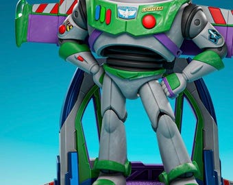 May include: A Buzz Lightyear action figure standing on a circular base with purple and green accents. The figure wears a white, green, and purple space suit with a clear helmet, featuring the text SPACE RANGER and LIGHTYEAR on the chest plate.